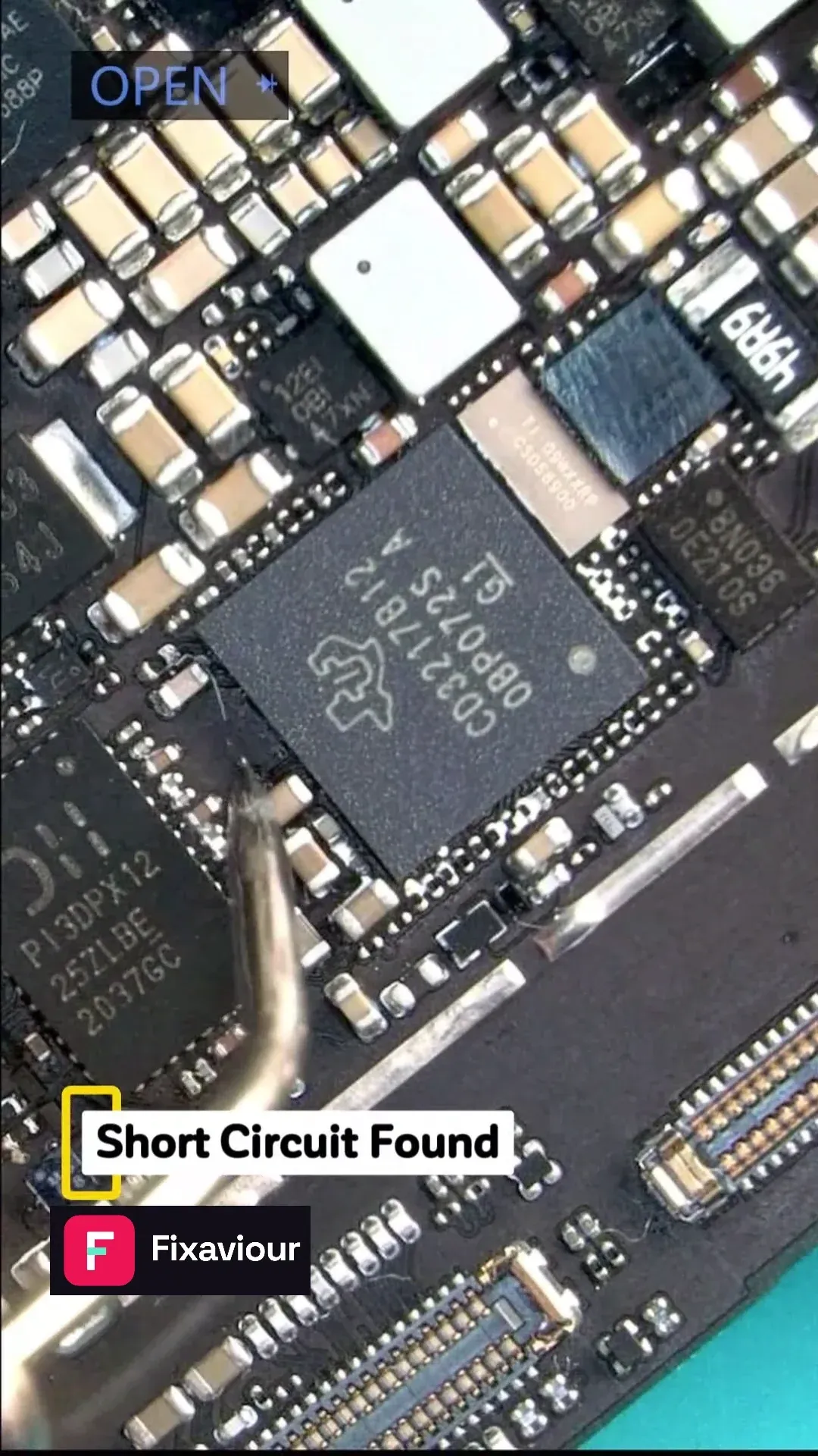 Probe beside the charging-circuit components on an iPad Air 4 logic board