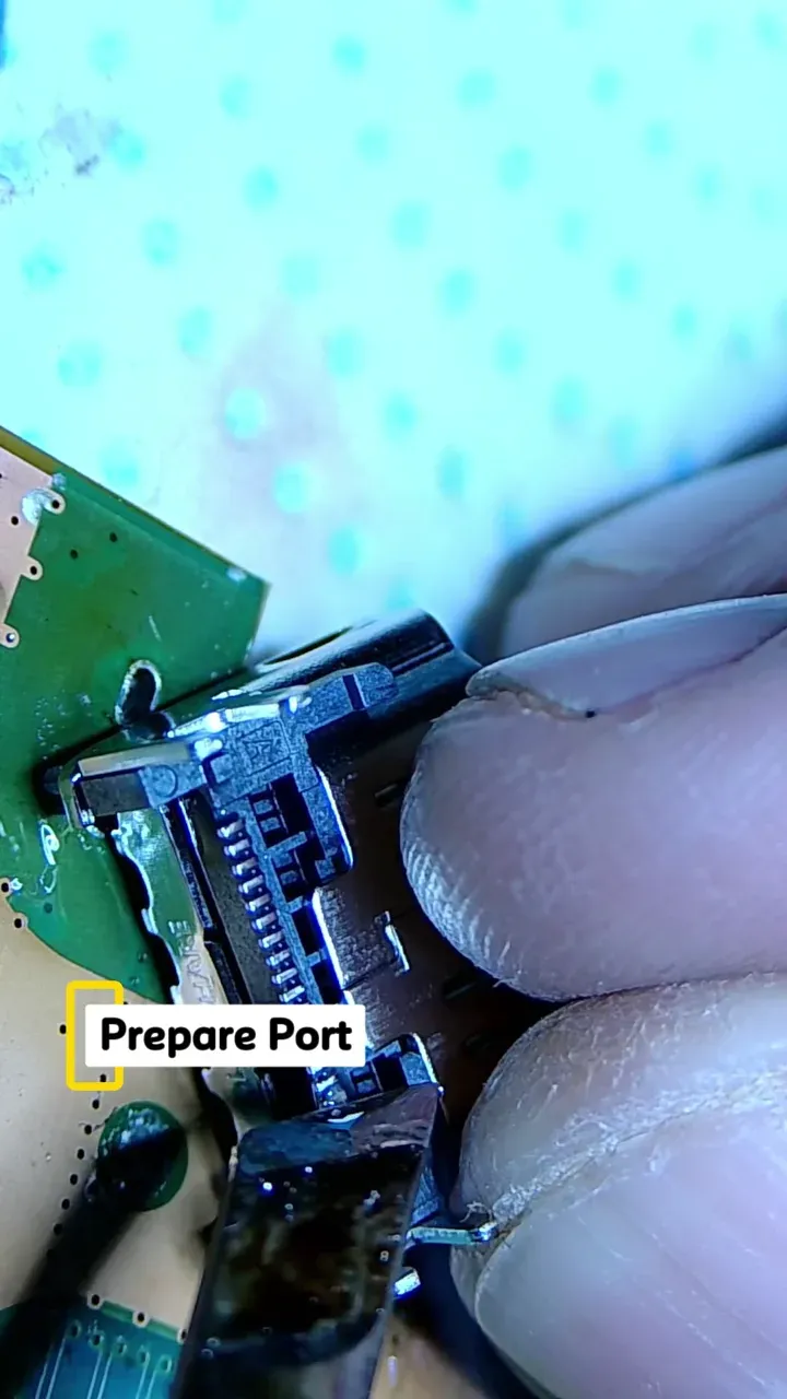 Replacement HDMI connector being soldered to a PS5 Digital board